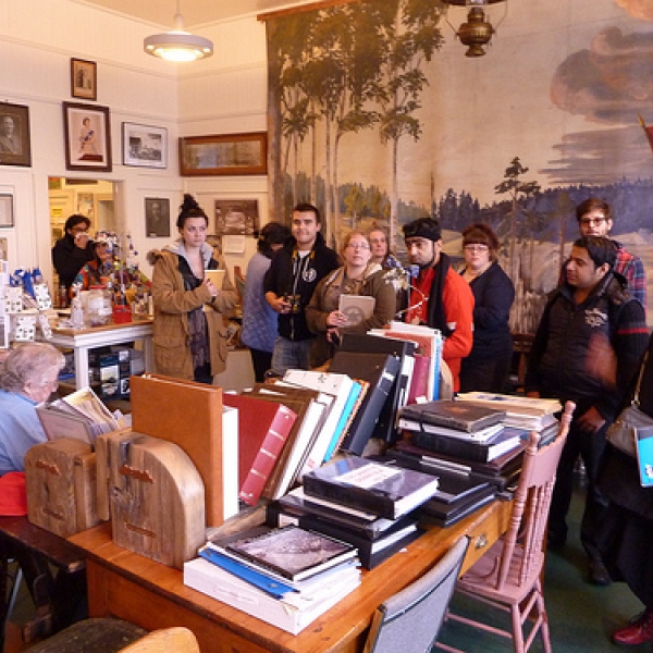 Naif, Angel, Esme, Pamela, Zak, Tamara, Kate, Usman, Mina, Yousif, Cory and Lynette. Aileen, seated, is the founder of the museum. 