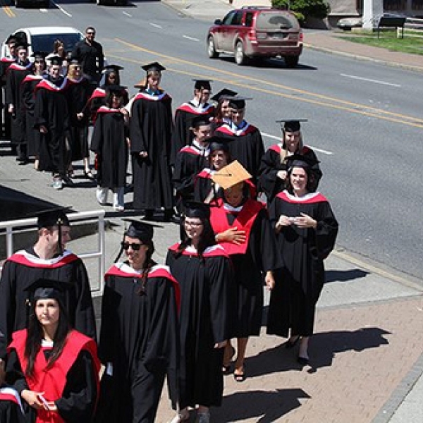 Procession Outside Port Theatre Desiree with cedar mortar board; Nicole immediately behind Desiree. Photo courtesy of VIU staff photographer. 