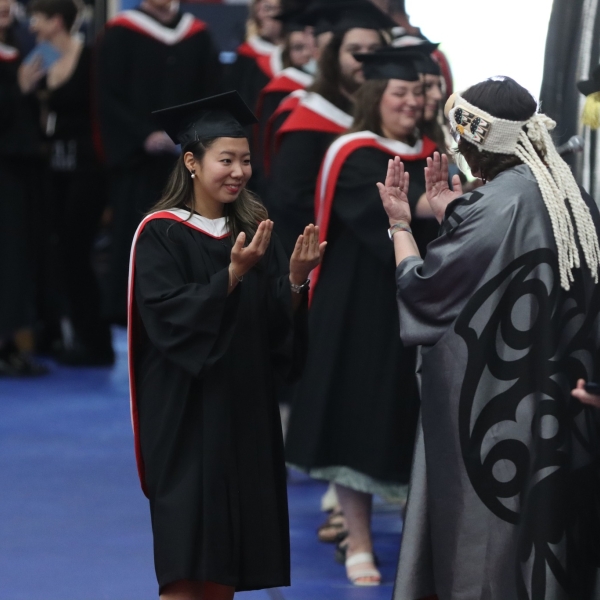 Jina You receiving her degree from President Saucier.  June 22, 2023.